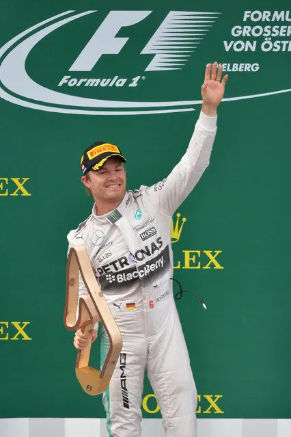 Mercedes driver German's Nico Rosberg celebrates his victory following the Austrian Formula One Grand Prix race at the Red Bull Ring in Spielberg, southern Austria, Sunday, June 21, 2015. (AP Photo/Kerstin Joensson)
