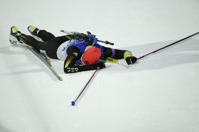 Denise Herrmann of Germany collapses at the finish line during the women's 15-kilometer individual race at the 2022 Winter Olympics, Monday, February 7, 2022, in Zhangjiakou, China. (Photo by Kirsty Wigglesworth/AP Photo)