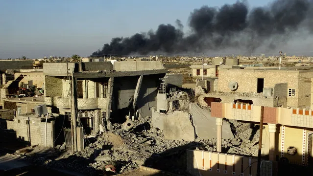 Smoke rises from Islamic State group positions after an airstrike by U.S.-led coalition warplanes in the Iraqi city of Ramadi in this December 25, 2015 file photo during the Iraqi government offensive that drove the militants out of the city. Ramadi, the provincial capital of Iraq's Sunni heartland, was declared “fully liberated” early this year. But the cost of victory may have been the city itself, with widespread destruction from strikes, artillery and the militants' scorched earth tactic of destroying buildings and infrastructure as they fled. (Photo by AP Photo)