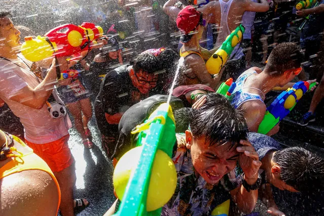 Revellers take part in a water fight at Songkran Festival celebrations in Bangkok, Thailand April 13, 2017. (Photo by Athit Perawongmetha/Reuters)