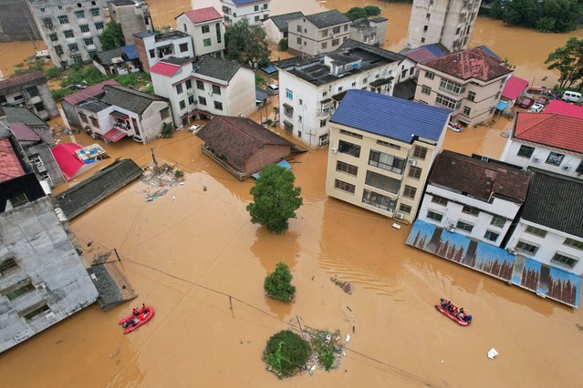 A drone view shows flooded buildings following heavy rainfall in Pingjiang county of Yueyang, Hunan province, China on July 2, 2024. (Photo by Reuters/China Stringer Network)