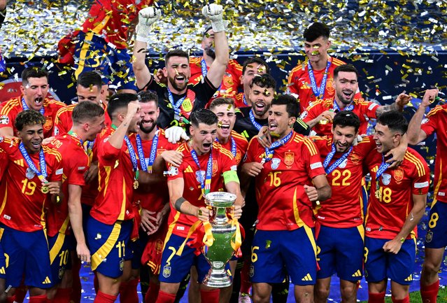 Spain's Alvaro Morata lifts the trophy as he celebrates with teammates after winning Euro 2024 on July 14, 2024. (Photo by Angelika Warmuth/Reuters)