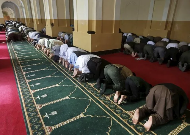 Men take part in morning prayers to celebrate the first day of the Muslim holiday of Eid-al-Fitr, marking the end of the holy month of Ramadan, at Eid Gah mosque in Kabul, Afghanistan, July 17, 2015. (Photo by Omar Sobhani/Reuters)