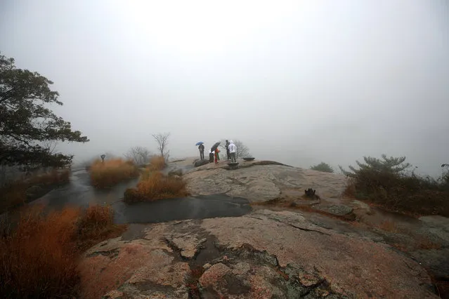 People enjoy the foggy view at Bear Mountain State Park during a rainy day in New York, United States on October 21, 2019. (Photo by Tayfun Coskun/Anadolu Agency via Getty Images)