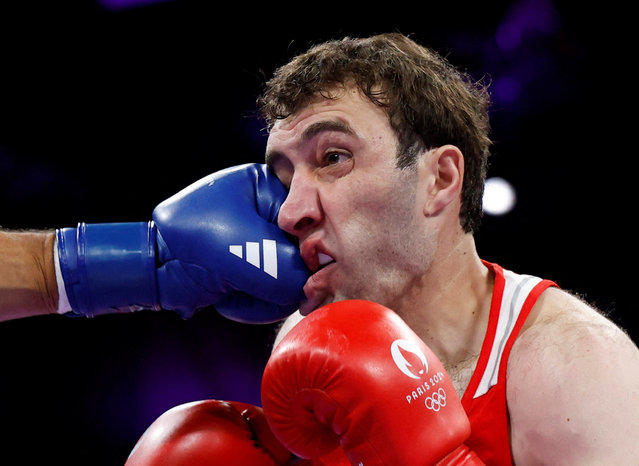 Davit Chaloyan of Armenia takes a punch from Delicious Orie of Great Britain, who lost after a controversial split decision in the super-heavyweight contest held at the Villepinte Exhibition Centre in Paris on July 29, 2024. (Photo by Peter Cziborra/Reuters)