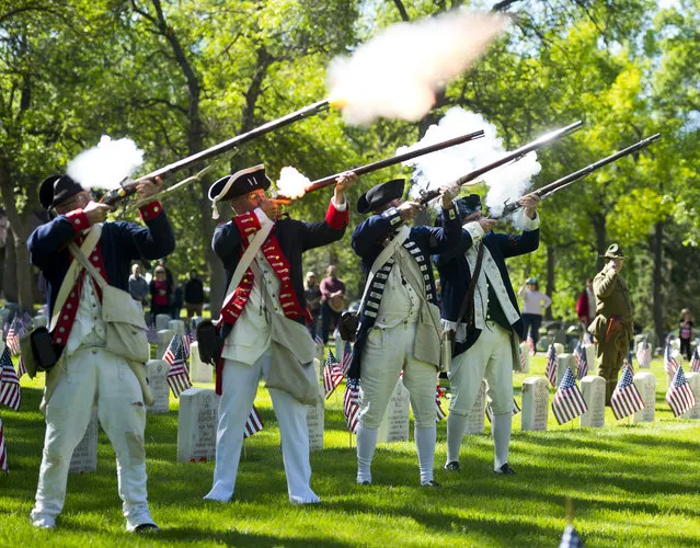 The Sons of the American Revolution, Pikes Peak Chapter fire their guns during a historic reenactment on Memorial Day at the Evergreen Cemetery on May 29, 2017 in Colorado Springs. (Photo by Dougal Brownlie/AP Photo/The Gazette)
