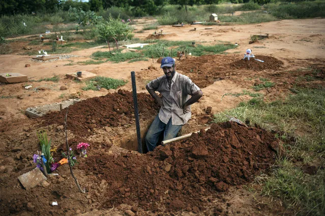 Cemetery worker Denny Pereyra rests momentarily while digging graves for children in an area of the municipal cemetery reserved for common graves in Maracaibo, Venezuela, November 28, 2019. Death has become an overwhelming financial burden for many of Venezuela’s poorest, who already struggle to find dignity in life. (Photo by Rodrigo Abd/AP Photo)