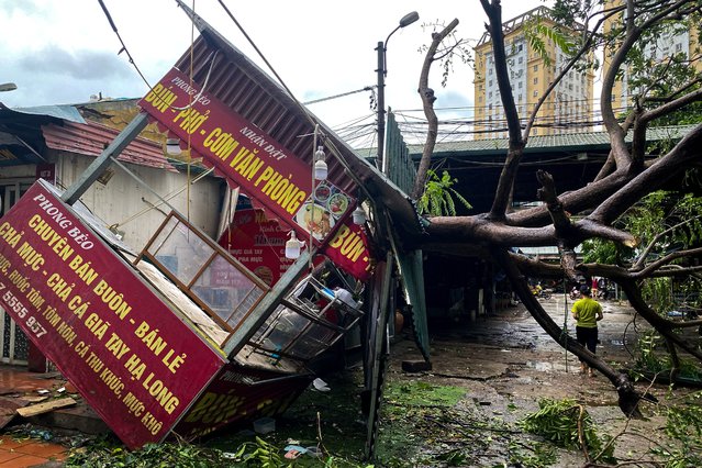 A man walks past a devastated area following the impact of Typhoon Yagi, in Hanoi, Vietnam, on September 8, 2024. (Photo by Thinh Nguyen/Reuters)