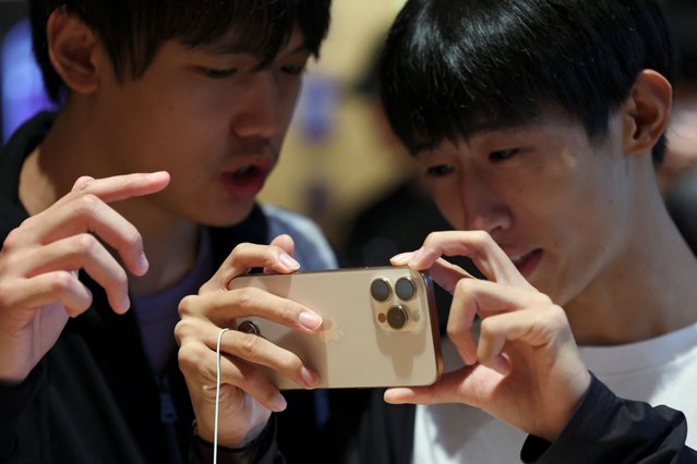 People check an iPhone 16 Pro as the new iPhone 16 series smartphones go on sale at an Apple store in Beijing, China on September 20, 2024. (Photo by Florence Lo/Reuters)