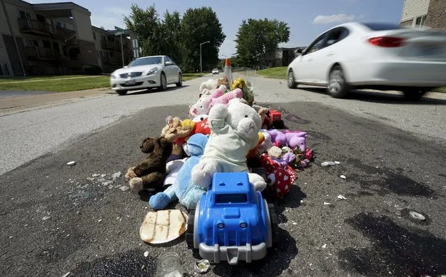 A collection of stuffed animals sits on the road in a memorial at the site where Michael Brown was killed nearly a year ago in Ferguson, Missouri August 7, 2015. One year after the police shooting of an unarmed black teen thrust Ferguson, into the national spotlight, the St. Louis suburb is bracing for a weekend of protests over continued complaints of police violence. (Photo by Rick Wilking/Reuters)