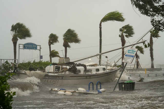 A boat washed ashore as storm surge affects Gulfport, Fla. as Hurricane Helene passed through the Gulf of Mexico to the West on September 26, 2024. (Photo by Thomas Simonetti for The Washington Post via Getty Images)