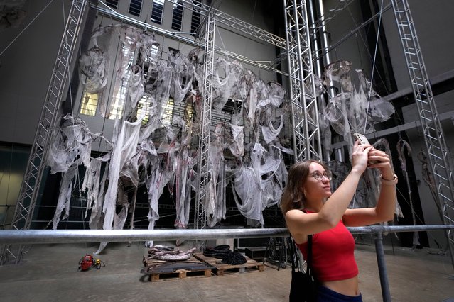 A visitor takes pictures at the Hyundai Commission: Mire Lee, on display in the Turbine Hall at the Tate Modern, in London, Tuesday, October 8, 2024, the exhibition will be open to the public from Oct. 9 2024 until March 16, 2025. (Photo by Kirsty Wigglesworth/AP Photo)