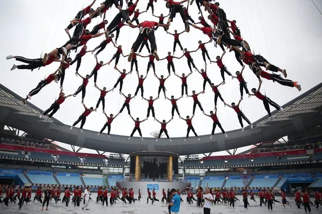 This picture taken on August 9, 2014 shows students from Tagou martial arts school performing during a rehearsal of the opening ceremony of Nanjing 2014 Youth Olympic Games in Nanjing, east China's Jiangsu province. The Nanjing 2014 Youth Olympic Games, which will be held from 16 to 28 August in Nanjing, uses the slogan of “Share the Games, Share our Dreams”. (Photo by AFP Photo)