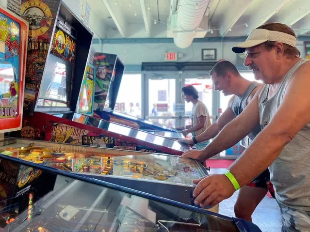 Guests try their luck at Silverball Retro Arcade, which is home to more than 150 fully functional pinball machines in Asbury Park, New Jersey, U.S., August 12, 2022. (Photo by Roselle Chen/Reuters)