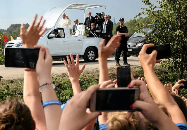 Pope Francis waves at the pilgrims as he arrives at the Campus Misericordiae during World Youth Day in Brzegi near Krakow, Poland July 31, 2016. (Photo by Agata Grzybowska/Reuters/Agencja Gazeta)