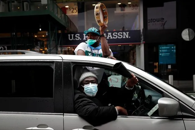 Demonstrators wearing protective face masks take part in a driving caravan protest calling for cancelling rent and workers rights during May Day protests in Manhattan during the outbreak of the coronavirus disease (COVID-19) in New York City, New York, U.S., May 1, 2020. (Photo by Mike Segar/Reuters)
