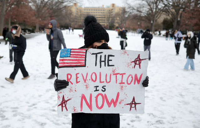 A protester displays a banner at Meridian Hill Park on the inauguration day of Donald Trump's second presidential term in Washington on January 20, 2025. (Photo by Marko Djurica/Reuters)