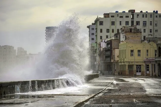 Huge waves crash against a seawall in the wake of Hurricane Ian in Havana, Cuba, Wednesday, Sept. 28, 2022. September 28, 2022. Cuba remained in the dark early Wednesday after Ian knocked out its power grid and devastated some of the country's most important tobacco farms when it hit the island's western tip as a major storm. (Photo by Ramon Espinosa/AP Photo)