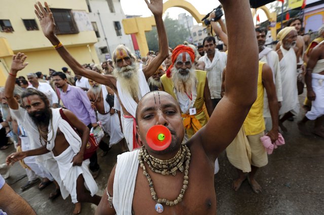 Sadhus or Hindu holy men chant religious hymns as they arrive to take a dip in the waters of Godavari river during the second “Shahi Snan” (grand bath) at Kumbh Mela or Pitcher Festival in Nashik, India, September 13, 2015. (Photo by Adnan Abidi/Reuters)