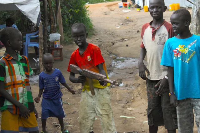 In this Monday, July 25, 2016 photo, a group of children at the U.N. protection of Civilians site in Juba, South Sudan, play with a makeshift gun. South Sudan's government has recruited child soldiers in the past week to prepare for a renewed conflict, according to an internal United Nations document obtained by The Associated Press. The document says a senior politician appointed by President Salva Kiir led the recruitment of an entire village of boys using intimidation. Some were as young as 12 years old. It was not clear how many children were involved. (Photo by Justin Lynch/AP Photo)