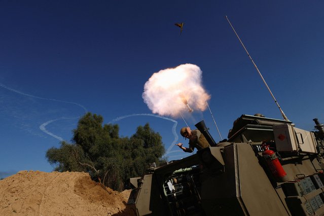 An Israeli soldier reacts while firing a mortar, as the conflict continues between Israel and the Palestinian Islamist group Hamas, on the border with the central Gaza, Israel on January 22, 2024. (Photo by Amir Cohen/Reuters)