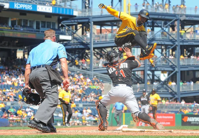 Andrew McCutchen #22 of the Pittsburgh Pirates is tagged out at home plate by J.T. Realmuto #11 of the Miami Marlins as part of a double play in the sixth inning during the game PNC Park on June 11, 2017 in Pittsburgh, Pennsylvania. (Photo by Justin Berl/Getty Images)