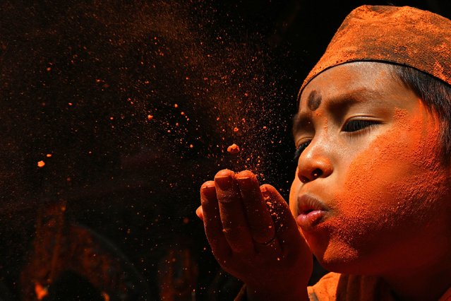 A person smeared in vermilion powder celebrates the Bisket Jatra festival in Thimi, Nepal, on Tuesday, April 15, 2025. (Photo by Prakash Mathema/AFP Photo)