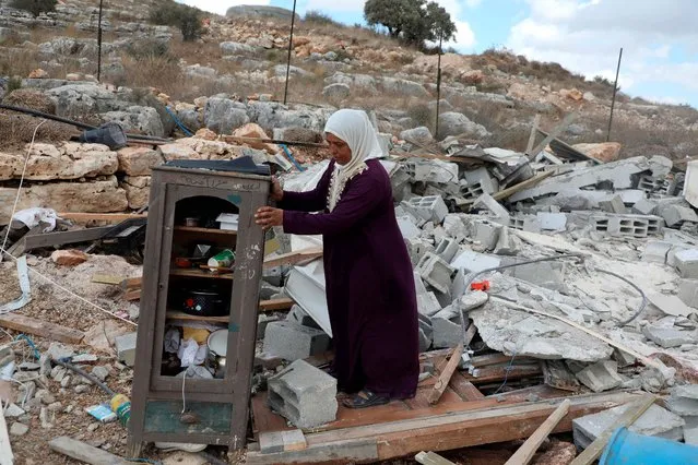 A Palestinan woman inspects the remains of her demolished house on August 10, 2020 near Jenin in the northern West Bank village of Farasin, where Israel insists it must approve any new residential construction and can tear down homes built without permits. (Photo by Jaafar Ashtiyeh/AFP Photo)