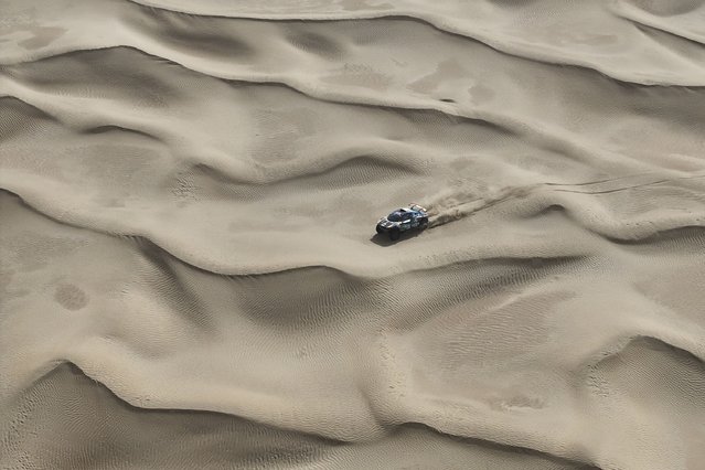 Hebei Qian'an Jiujiang Automobile and Motorcycle Sports Team's Gaoxiang Fan of China drives with co-driver Liguo Fu of China in the JJ-sport JJ3 in the Classe : T1+ during Stage 6 of the Taklimakan Rally 2025, between Keriya River and Yutian, on May 27, 2025 in Xinjiang Uygur Autonomous Region, China. The Taklimakan Rally was founded in 2005 in Xinjiang, China. Relying on the natural landform of three mountains with two basins in Xinjiang and centered on Taklimakan Desert, the Sea of Death, it extends to Tarim Basin, Turpan-Hami Basin and Gurbantunggut Desert. There will be some changes in competition routes every year. The 2025 Taklimakan Rally will last for 13 days, with a total mileage of about 5,183 kilometers, of which desert sections account for 65%, Gobi sections account for 15%, and gravel sections account for 20%. There are 4 camps and 10 special stages of about 2,350 kilometers in the entire stage. The competition has set up 4 participating groups, including motorcycle group, car group, truck group, and new energy group. (Photo by Zhe Ji/Getty Images)