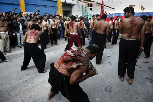 Shi'ite Muslims flagellate themselves during a Muharram procession marking Ashoura in Piraeus port town, near Athens November 4, 2014. Ashoura, which falls on the 10th day of the Islamic month of Muharram, commemorates the death of Imam Hussein, grandson of Prophet Mohammad, who was killed in the seventh century battle of Kerbala. (Photo by Yorgos Karahalis/Reuters)