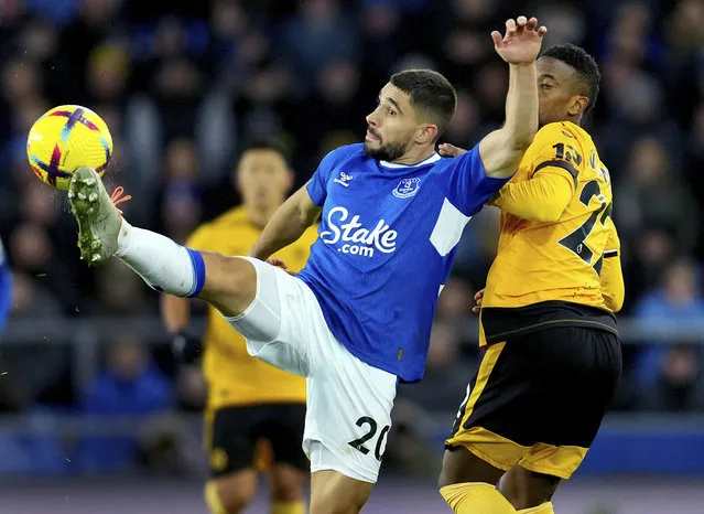 Everton's Neal Maupay, left, and Wolverhampton Wanderers' Nelson Semedo, right, challenge for the ball during the Premier League soccer match between FC Everton and Wolverhampton Wanderers at Goodison Park in Liverpool, England, Monday, December 26, 2022. (Photo by Jon Super/AP Photo)