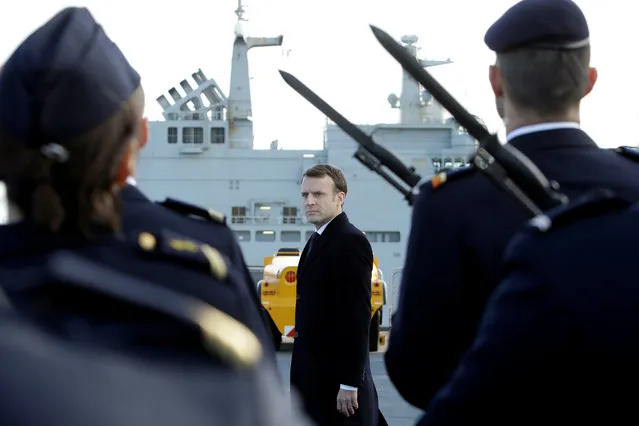 French President Emmanuel Macron reviews an honor guard upon his arrival on board of the French war ship Dixmude docked in the French Navy base of Toulon, southern France on January 19, 2018, before delivering a speech to present his New Year's wishes to the French Army. (Photo by Claude Paris/Reuters)