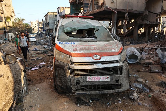 Palestinians inspect the damage, including a destroyed ambulance, around a house hit in an Israeli strike a day earlier in western Beit Lahia in the northern Gaza Strip on July 23, 2025. (Photo by Omar Al-Qattaa/AFP Photo)