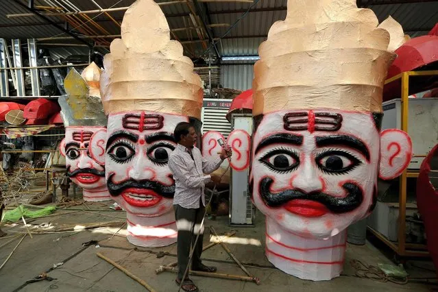 Artists work on effigies of demon King Ravana during preparations for the upcoming Dussehra festival in Bhopal, India, 22 October 2020. The festival takes place on the tenth day of the waxing moon during the Hindu month of Ashvin (around September or October). On this day, Rama (god-king and hero of the great Hindu epic Ramayana) vanquished the evil Ravana, the ten-headed demon-king of Lanka who abducted Rama's wife Sita, according to the legend. (Photo by Sanjeev Gupta/EPA/EFE)