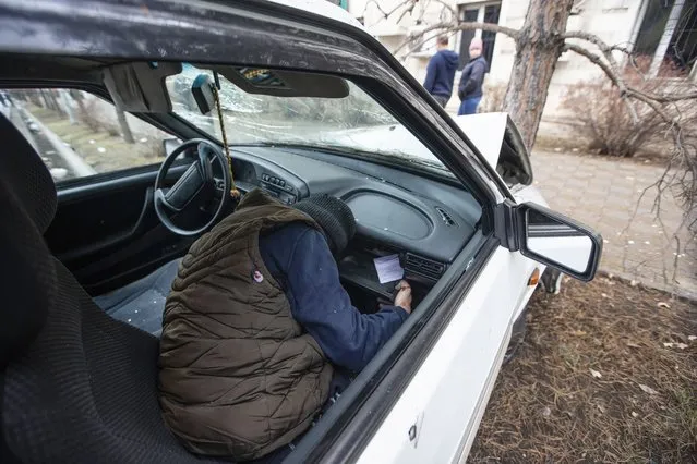 The body of a victim is seen in a damaged car in Almaty, Kazakhstan, Friday, January 7, 2022. On Jan. 6, security forces killed dozens of protesters. President Kassym-Jomart Tokayev said he had given security forces shoot-to-kill orders to halt the violent unrest, saying: “We intend to act with maximum severity regarding lawbreakers”. ​(Photo by Vasily Krestyaninov/AP Photo)