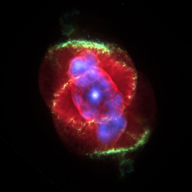 The interior of a planetary nebula glows in radient colors January 9, 2001 in an image taken by NASA's Chandra X-ray Observatory. Astronomers unexpectedly found a central star in the late stages of life emitting powerful X-ray energy. The X-ray observations of the Cat's Eye Nebula reveal a hot gas cloud around a bright star, which is shedding its material and is expected to collapse into a white dwarf in several million years. (Photo by NASA/Newsmakers)