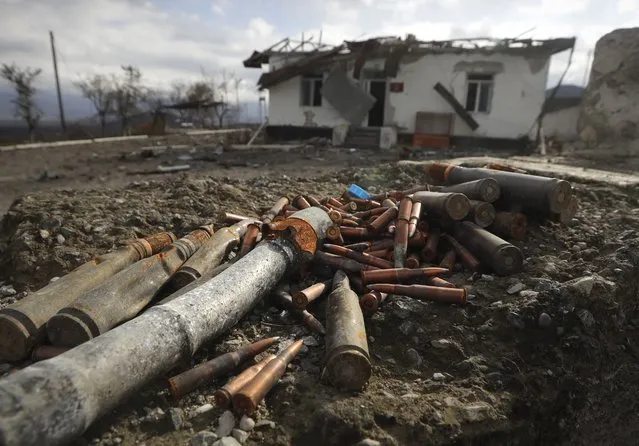 Unexploded ammunition scattered at a damaged ammunition store near Aeygestan, in outskirts of Stepanakert, the capital of the separatist region of Nagorno-Karabakh, Monday, November 23, 2020. The ammunition store was hit by Azerbaijanian forces on Oct. 5 and will be soon cleared of unexploded rockets, cannon rounds and grenades. (Photo by Sergei Grits/AP Photo)