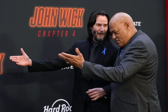 Keanu Reeves, left, and Laurence Fishburne, cast members in “John Wick: Chapter 4”, walk the carpet together at the premiere of the film, Monday, March 20, 2023, at the TCL Chinese Theatre in Los Angeles. (Photo by Chris Pizzello/AP Photo)