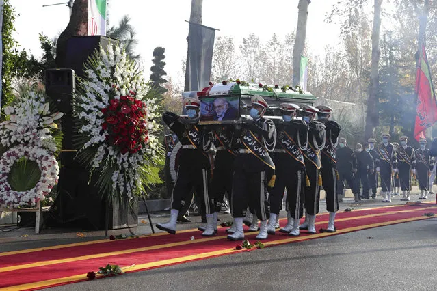 In this photo released by the official website of the Iranian Defense Ministry, military personnel carry the flag draped coffin of Mohsen Fakhrizadeh, a scientist who was killed on Friday, in a funeral ceremony in Tehran, Iran, Monday, November 30, 2020. Iran held the funeral Monday for the slain scientist who founded its military nuclear program two decades ago, with the Islamic Republic's defense minister vowing to continue the man's work “with more speed and more power”. (Photo by Iranian Defense Ministry via AP Photo)