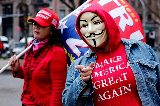 Supporters of former US president Donald Trump protest outside the Manhattan District Attorney's office in New York City on April 3, 2023. Donald Trump arrived at his New York skyscraper on the eve of his surrender to face unprecedented criminal charges that threaten to throw the entire 2024 White House race into turmoil. The 76-year-old Republican, the first US president ever to be criminally indicted, will be formally charged on April 4, 2023 over hush money paid to a p*rn star during the 2016 election that brought him to power. (Photo by Leonardo Munoz/AFP Photo)