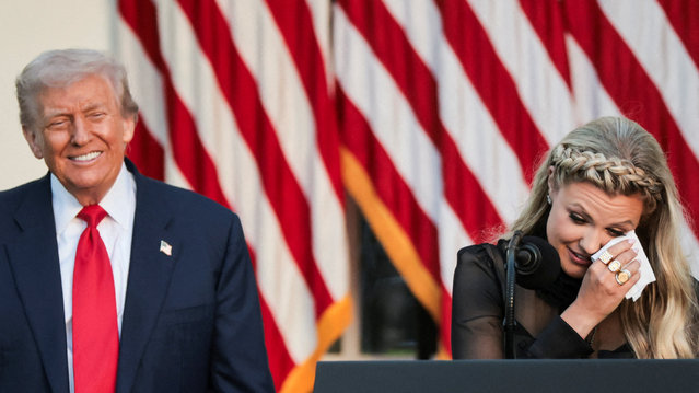 President Trump reacts beside Erika Kirk, wife of slain conservative commentator Charlie Kirk and the new CEO of Turning Point USA, as she wipes a tear while delivering a speech during a ceremony to posthumously award the Medal of Freedom to Charlie Kirk in the Rose Garden at the White House, on October 14, 2025. (Photo by Jonathan Ernst/Reuters)