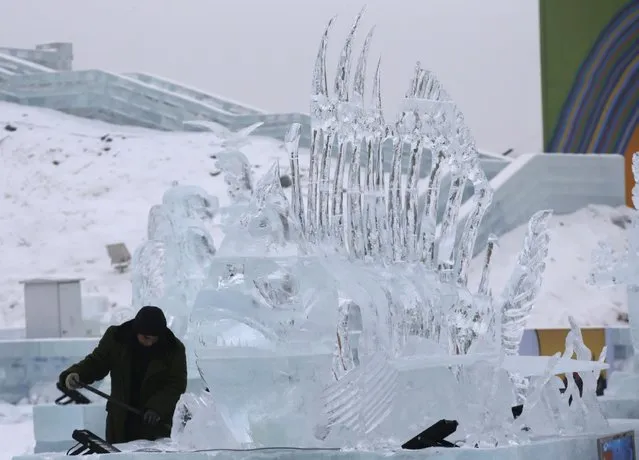 A worker polishes an ice sculpture ahead of the 31st Harbin International Ice and Snow Festival in the northern city of Harbin, Heilongjiang province, January 4, 2015. (Photo by Kim Kyung-Hoon/Reuters)