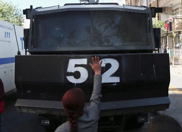 Besime Konca, a parliamentarian from the pro-Kurdish Peoples' Democratic Party (HDP), reacts at an armored police vehicle during a protest against the arrest of the city's popular two joint mayors for alleged links to terrorism, in the Kurdish-dominated southeastern city of Diyarbakir, Turkey, October 26, 2016. (Photo by Sertac Kayar/Reuters)