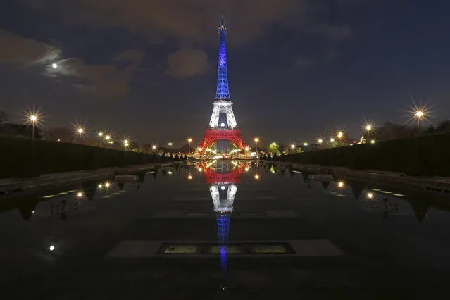 The Eiffel Tower lit with the blue, white and red colours of the French flag is reflected in the Trocadero fountains in Paris, France, November 23, 2015, a week after a series of deadly attacks in the French capital. (Photo by Christian Hartmann/Reuters)