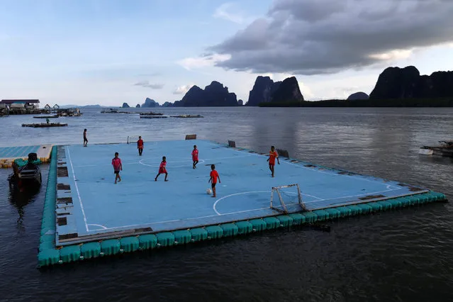 Children play soccer on a floating pitch in the fishing village of Ko Panyi in southern Phang Nga Province, Thailand, May 20, 2018. (Photo by Soe Zeya Tun/Reuters)