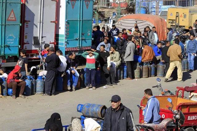 People wait in line to buy gas cylinders at a distribution point in Cairo January 19, 2015. (Photo by Mohamed Abd El Ghany/Reuters)