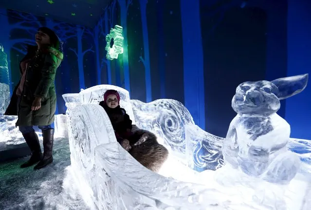 A woman with a child visit an ice room with ice sculptures at a mall in Minsk, Belarus, December 7, 2015. (Photo by Vasily Fedosenko/Reuters)