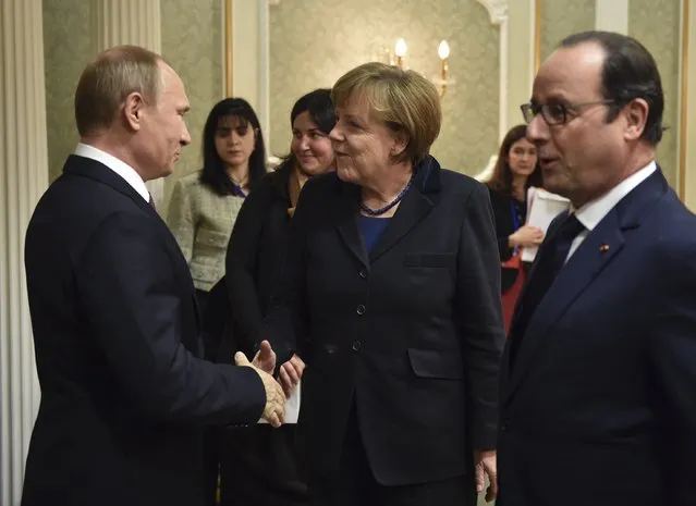 Russia's President Vladimir Putin (L), shakes hands with Germany's Chancellor Angela Merkel as France's President Francois Hollande stands nearby during a meeting on resolving the Ukrainian crisis in Minsk, February 11, 2015. (Photo by Mykola Lazarenko/Reuters)