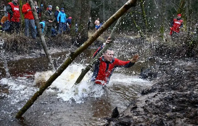 Belarussian tourists cross the river as they take part in “Search and rescue operations – 2016”, a three-day competition, near the village of Priselki, Belarus, November 25, 2016. Photo taken November 25, 2016. (Photo by Vasily Fedosenko/Reuters)