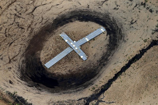 Pontoons, which were previously used as a floating jetty, are seen on the cracked ground of the Atibainha dam, part of the Cantareira reservoir, during a drought in Nazare Paulista, Sao Paulo state February 12, 2015. (Photo by Paulo Whitaker/Reuters)